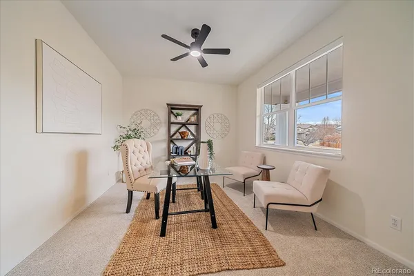 a workspace room with furniture and window