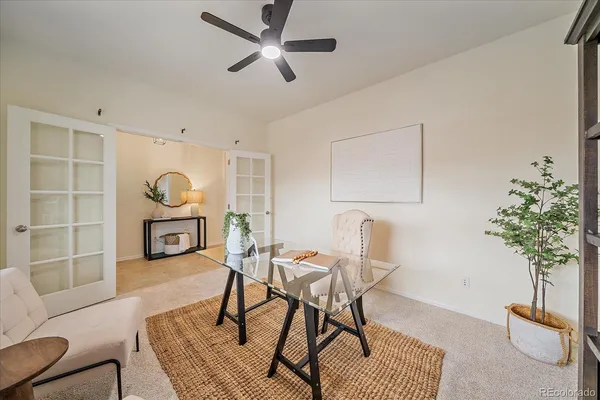 a living room with furniture a chandelier and a potted plant