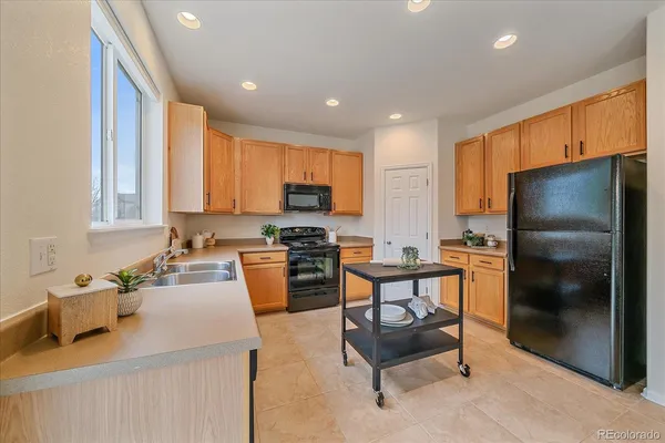a kitchen with a refrigerator and a sink