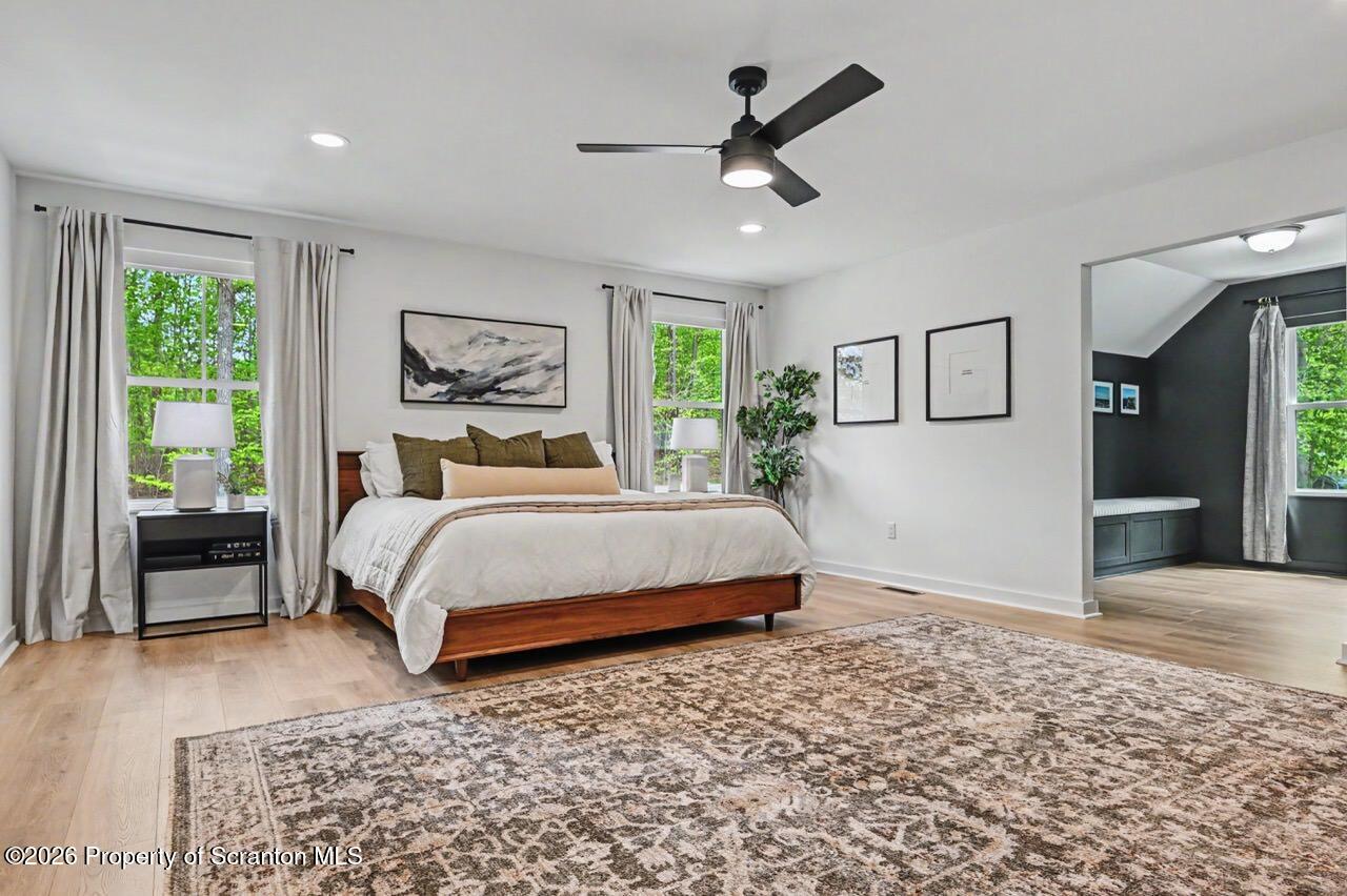 100 Highland Road Moscow, PA 18444 - Photo 70 of 85 a bedroom with a large bed and a chandelier