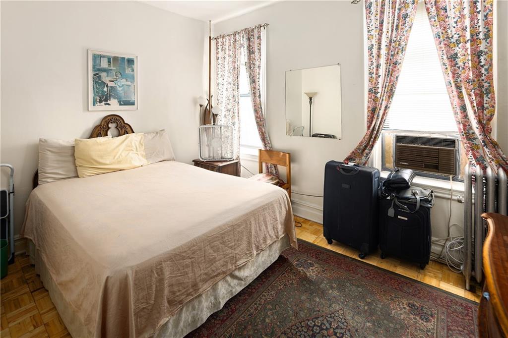 1088 Lenox Road Brooklyn, NY 11212 - Photo 6 of 9 a bedroom with a bed a flat tv screen and dresser