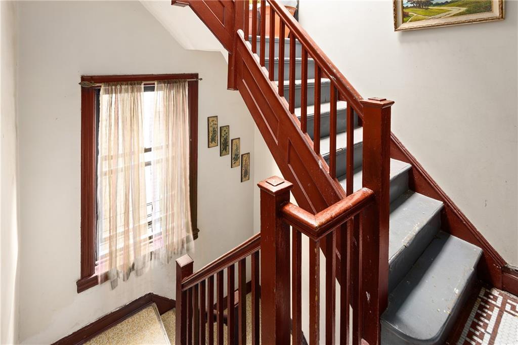 1088 Lenox Road Brooklyn, NY 11212 - Photo 7 of 9 a view of staircase with wooden floor and white walls