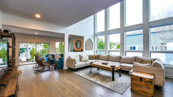 a balcony with wooden floor outdoor seating and city view