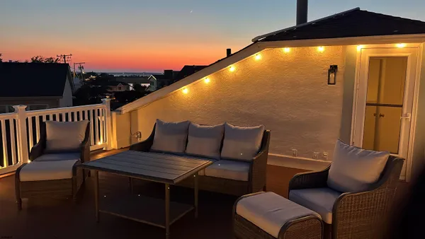 a living room with furniture a fireplace and a large window