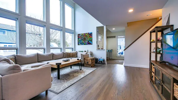 a spacious bathroom with a granite countertop tub sink shower and mirror