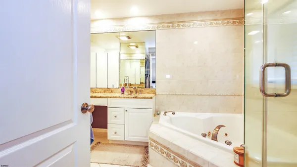 a view of a hallway with couch and a painting on the wall