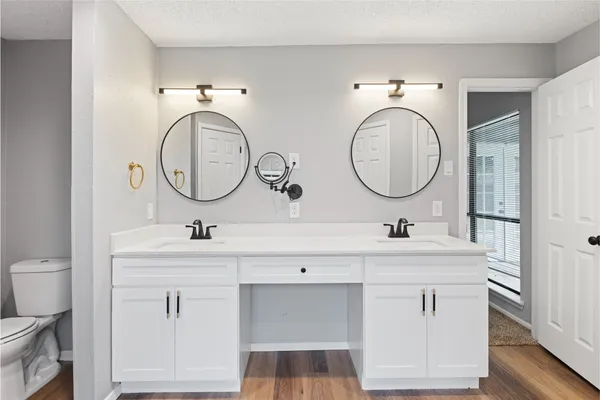 a bathroom with a toilet sink and mirror
