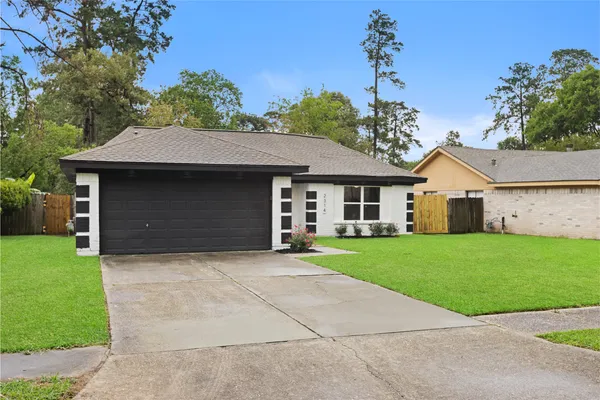 a front view of a house with a garden and yard