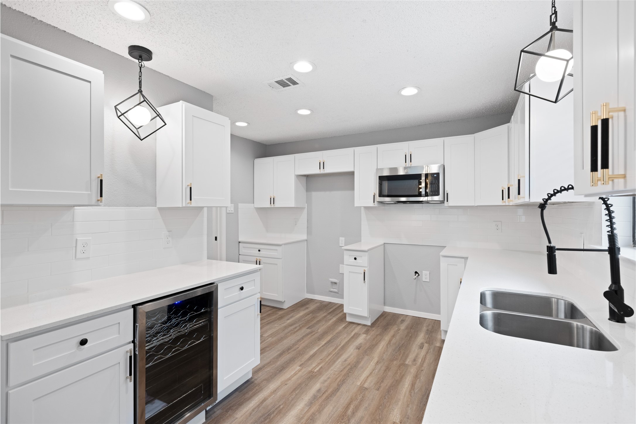 2314 Peaceful Valley Drive Spring, TX 77373 - Photo 8 of 20 a kitchen with granite countertop a sink stainless steel appliances and white cabinets