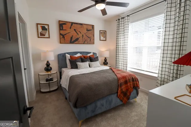 a bedroom with a bed and a large window