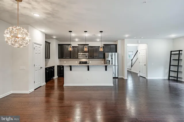 a view of kitchen with cabinets and wooden floor