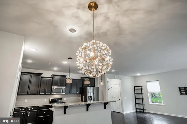 a kitchen with stainless steel appliances a refrigerator sink and stove