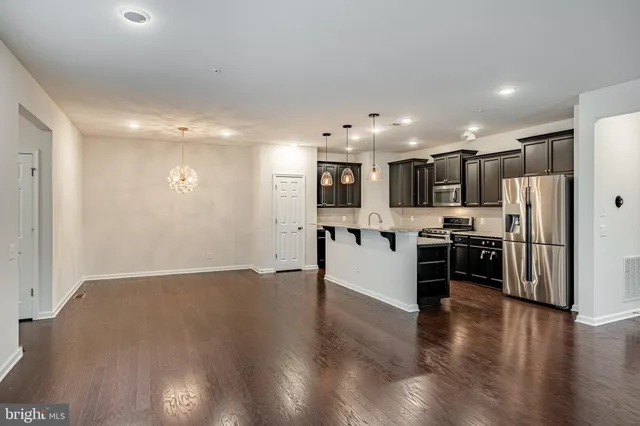 a view of kitchen with stainless steel appliances a refrigerator and a stove top oven