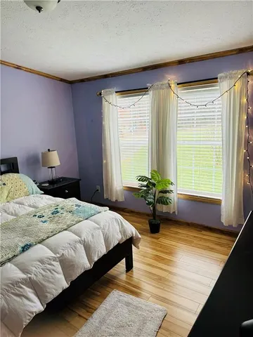 a bedroom with a bed and a mirror on the dresser