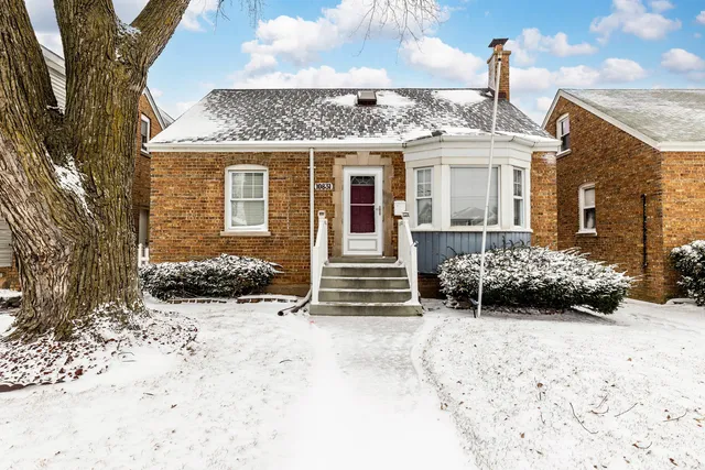 a view of a house with a yard covered in snow