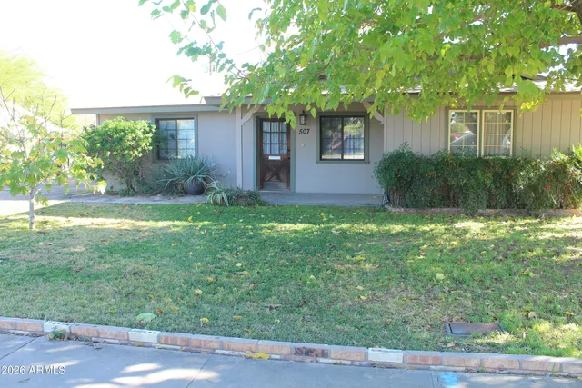 a view of a house with a yard