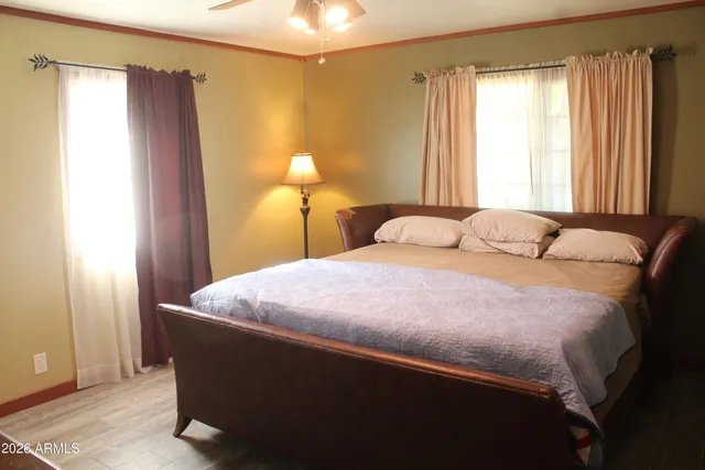 a bedroom with a bed and a window