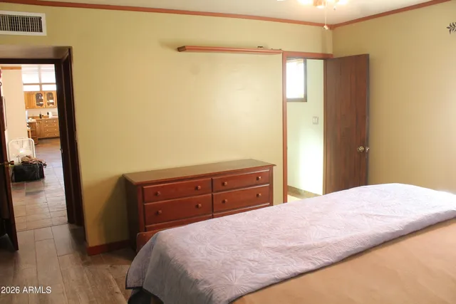 a bedroom with a bed and a dresser