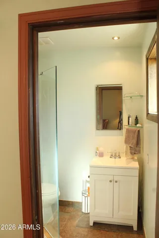 a bathroom with a sink a mirror and a shower