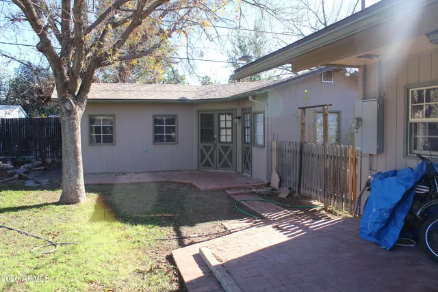 a view of backyard with a large tree