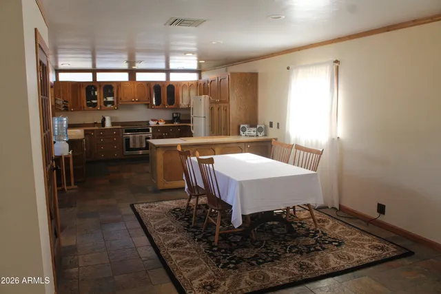a large kitchen with a table and chairs