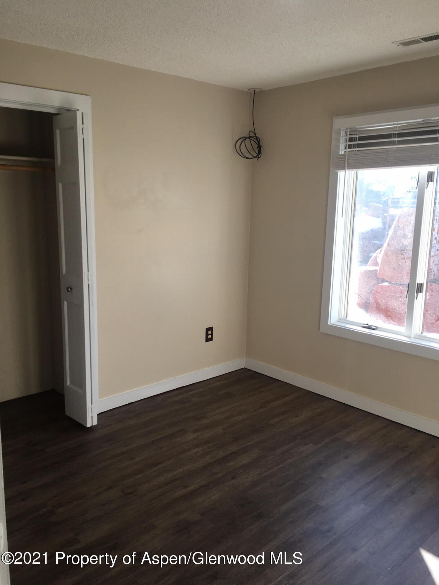 1101 Village Road, Unit LL3B Carbondale, CO 81623 - Photo 13 of 17 an empty room with wooden floor and windows