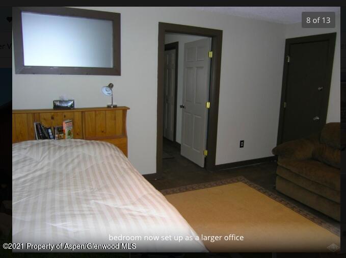 1101 Village Road, Unit LL3B Carbondale, CO 81623 - Photo 5 of 17 a bedroom with a bed and a flat screen tv