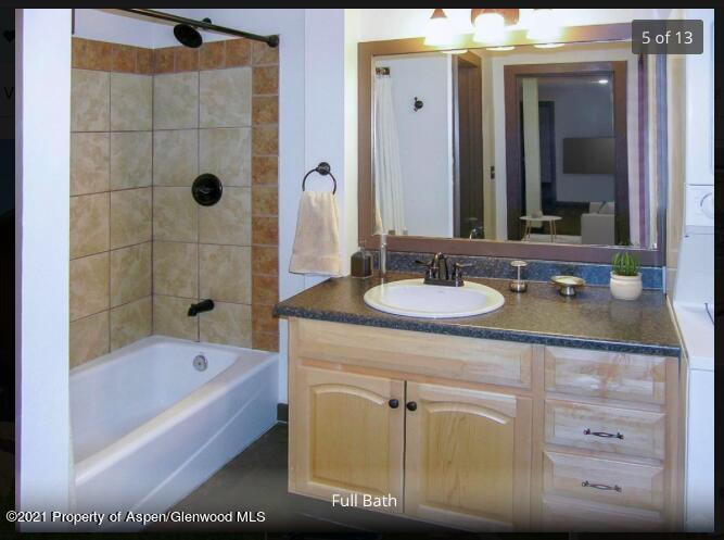1101 Village Road, Unit LL3B Carbondale, CO 81623 - Photo 7 of 17 a bathroom with a granite countertop sink a mirror and bathtub