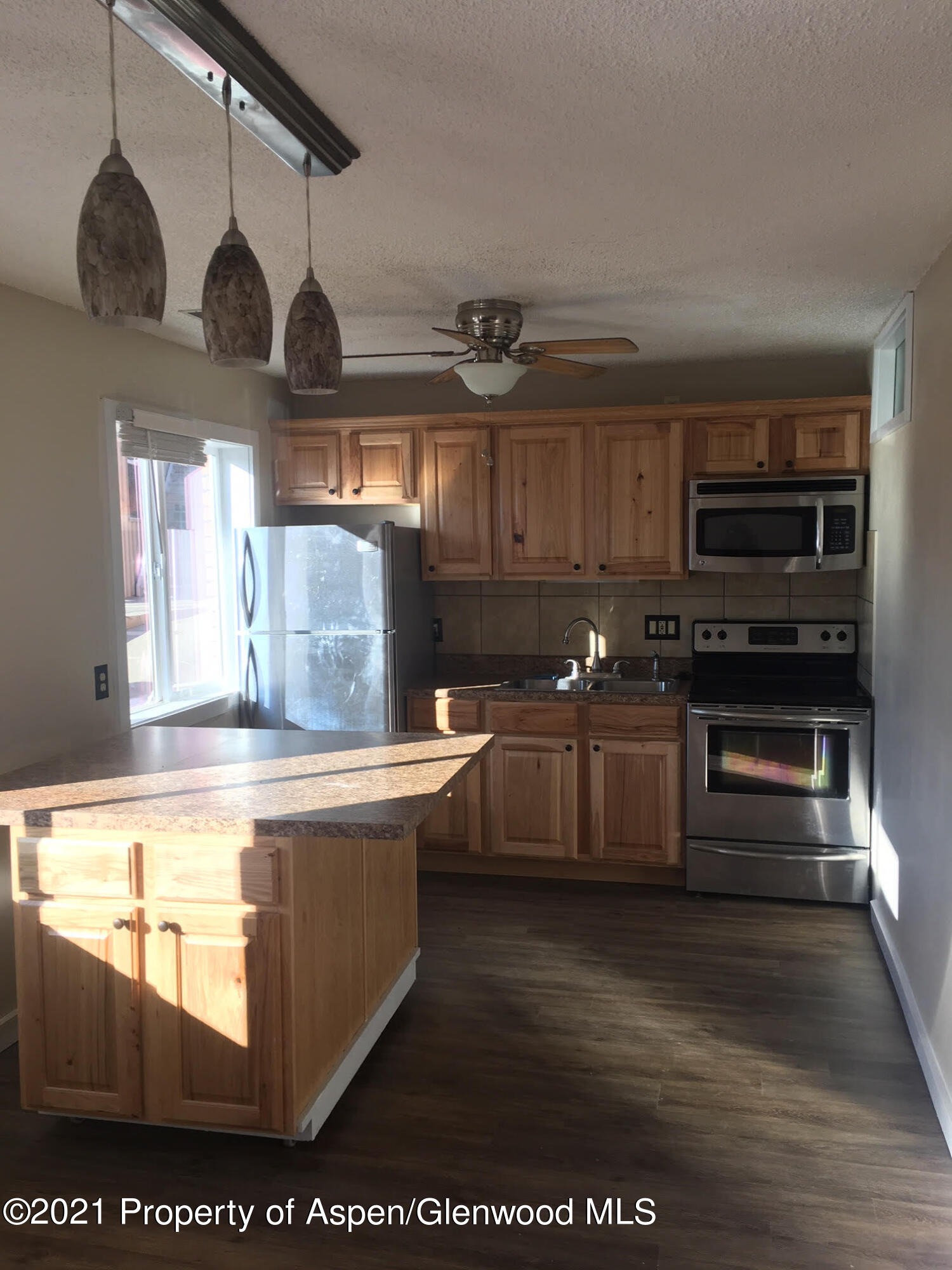 1101 Village Road, Unit LL3B Carbondale, CO 81623 - Photo 9 of 17 a kitchen with stainless steel appliances granite countertop a stove a sink and a microwave