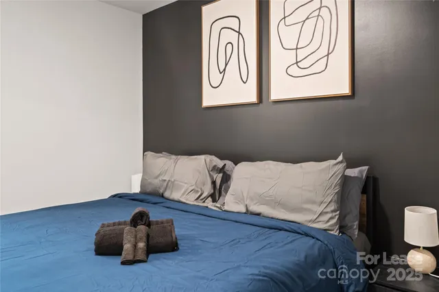 a bedroom with a bed and a night stand