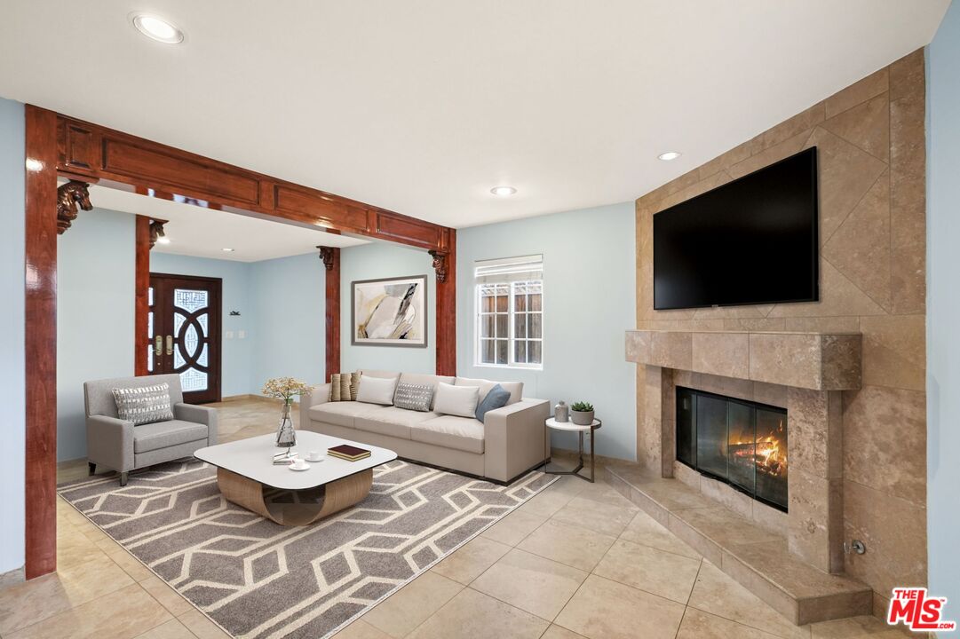 148 Van Nuys Avenue Oxnard, CA 93035 - Photo 13 of 37 a living room with furniture a fireplace and a flat screen tv