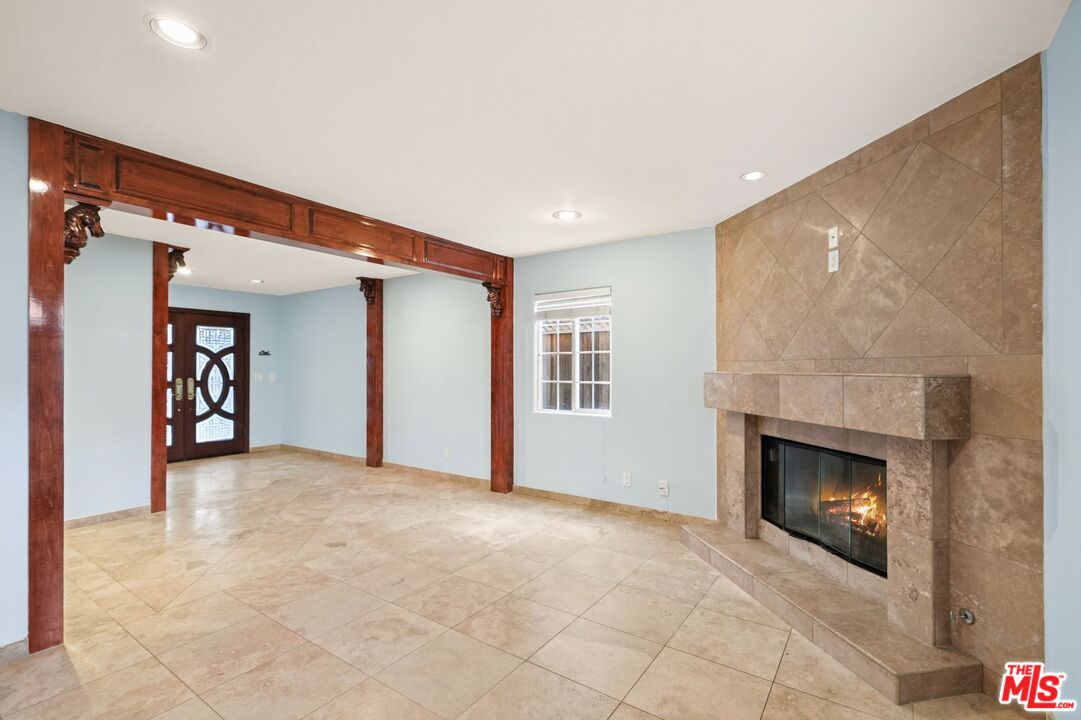 148 Van Nuys Avenue Oxnard, CA 93035 - Photo 5 of 37 a view of an empty room with a fireplace and a window