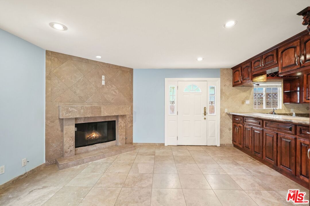148 Van Nuys Avenue Oxnard, CA 93035 - Photo 6 of 37 a view of an empty room with a fireplace and a window