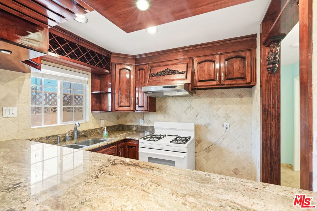 148 Van Nuys Avenue Oxnard, CA 93035 - Photo 8 of 37 a kitchen with stainless steel appliances granite countertop a sink and a stove