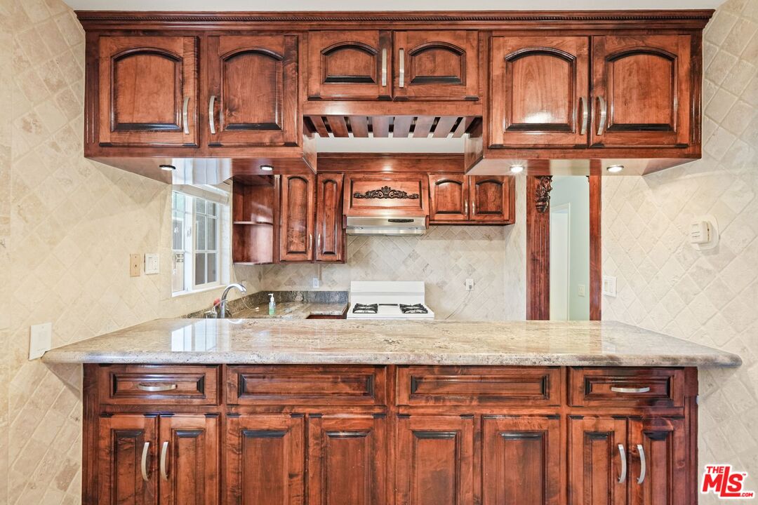 148 Van Nuys Avenue Oxnard, CA 93035 - Photo 9 of 37 a kitchen with stainless steel appliances granite countertop a sink and cabinets