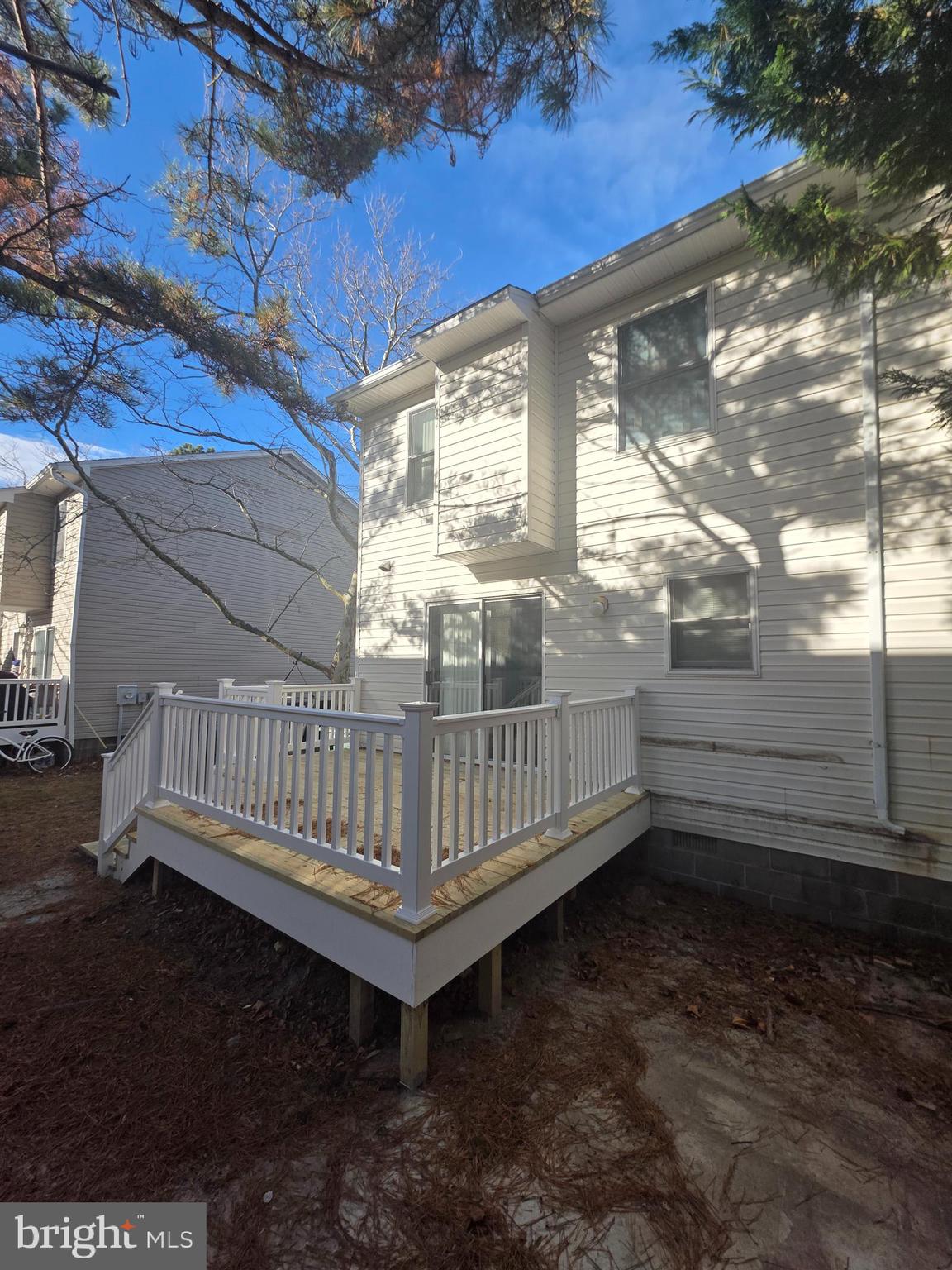 153 Captains Quarters Road Ocean City, MD 21842 - Photo 21 of 22 a view of a yard with wooden floor and iron fence