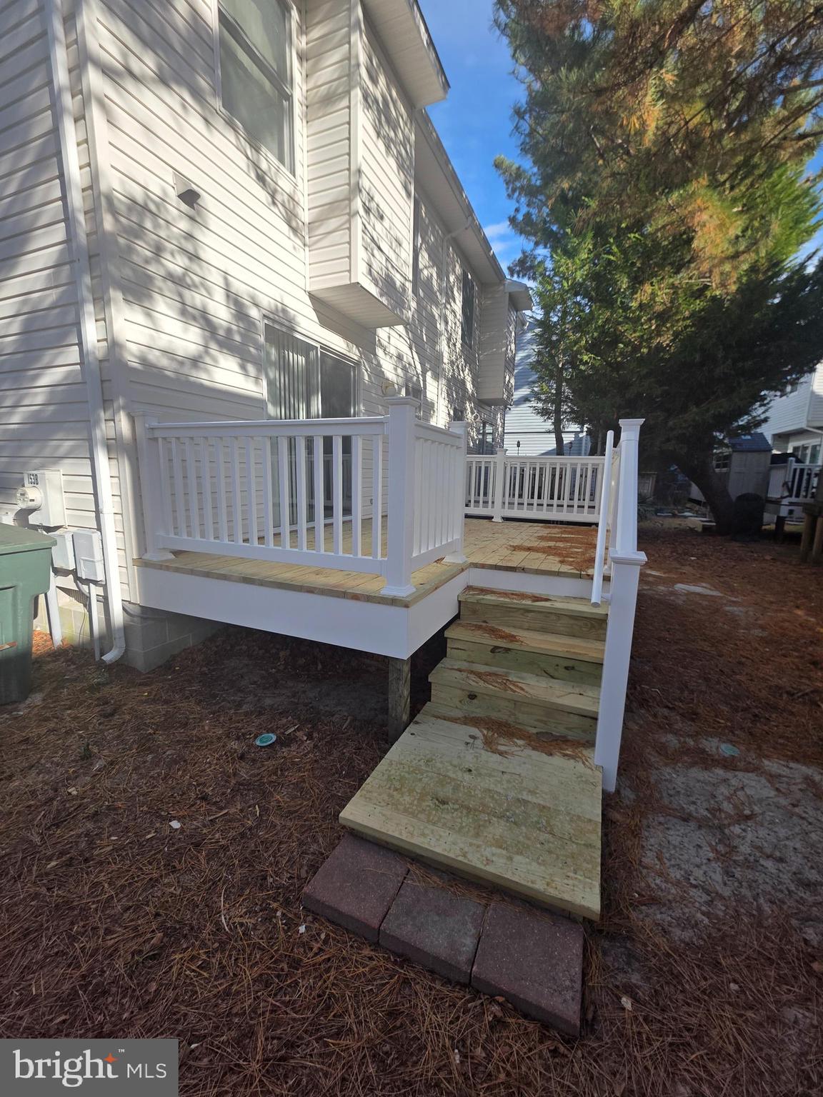 153 Captains Quarters Road Ocean City, MD 21842 - Photo 22 of 22 a view of a wooden deck with chairs and a yard