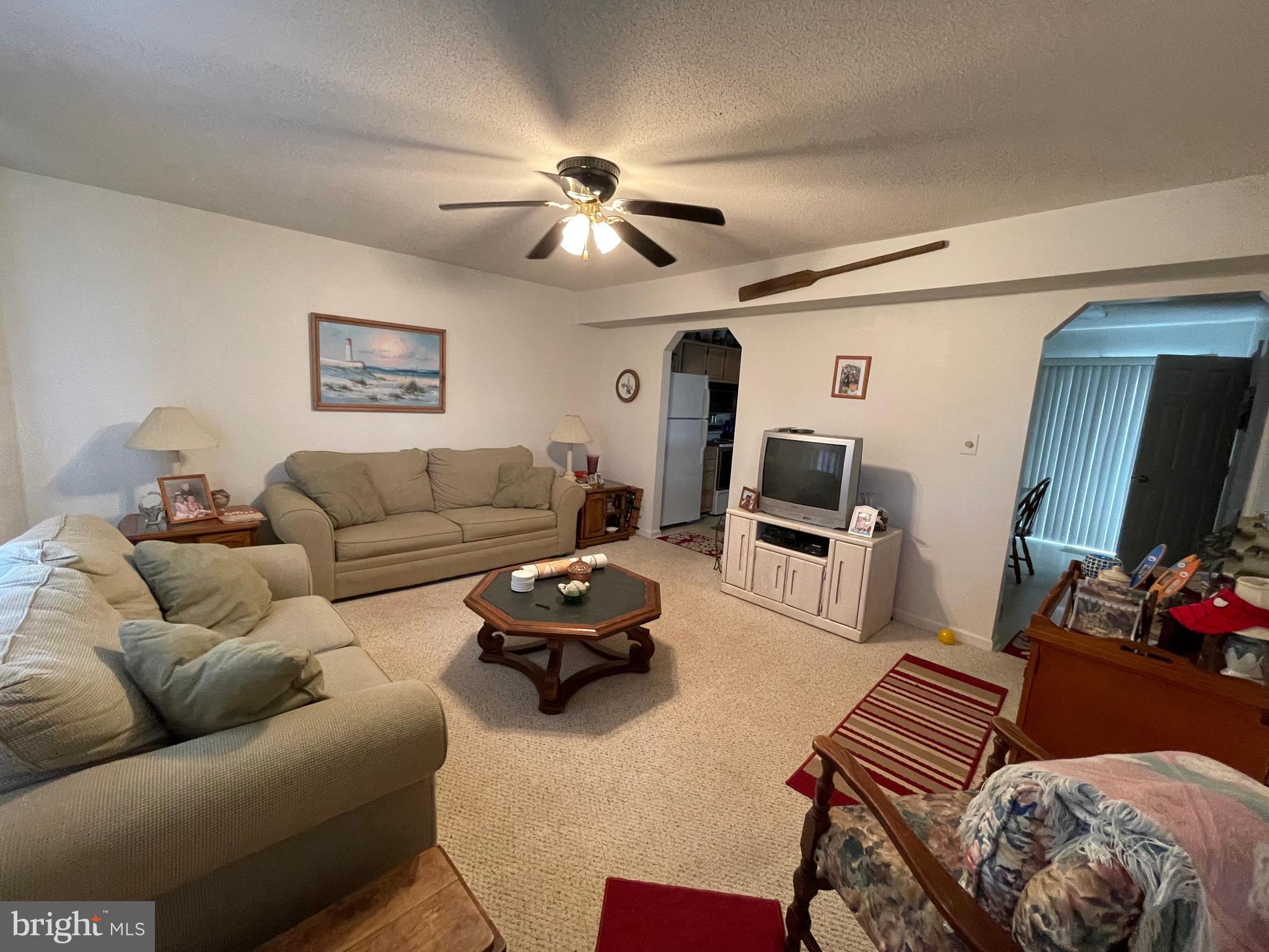 153 Captains Quarters Road Ocean City, MD 21842 - Photo 3 of 22 a living room with furniture and a flat screen tv