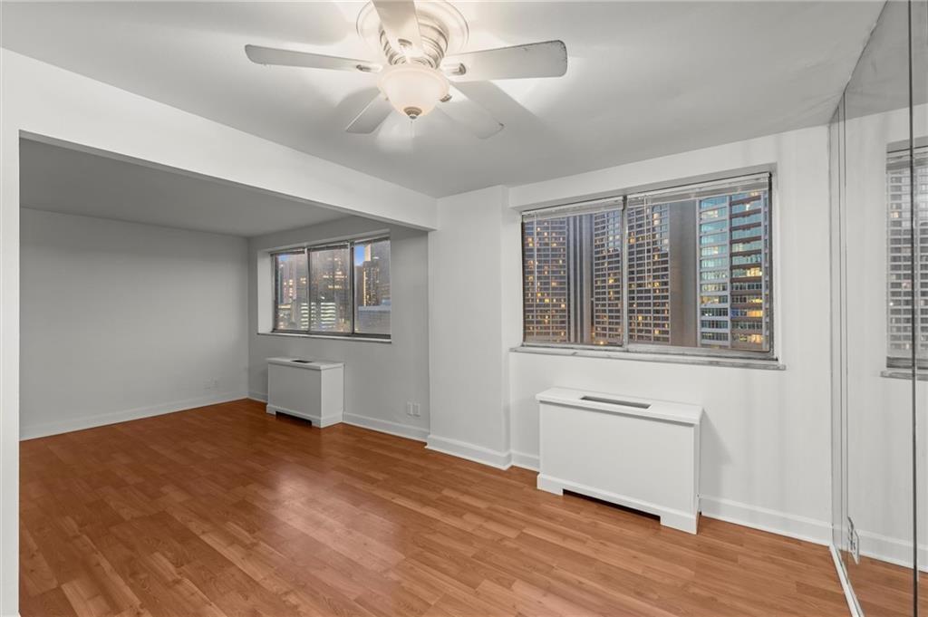 215 Piedmont Avenue Northeast, Unit 1608 Atlanta, GA 30308 - Photo 17 of 25 a view of empty room with wooden floor and fan