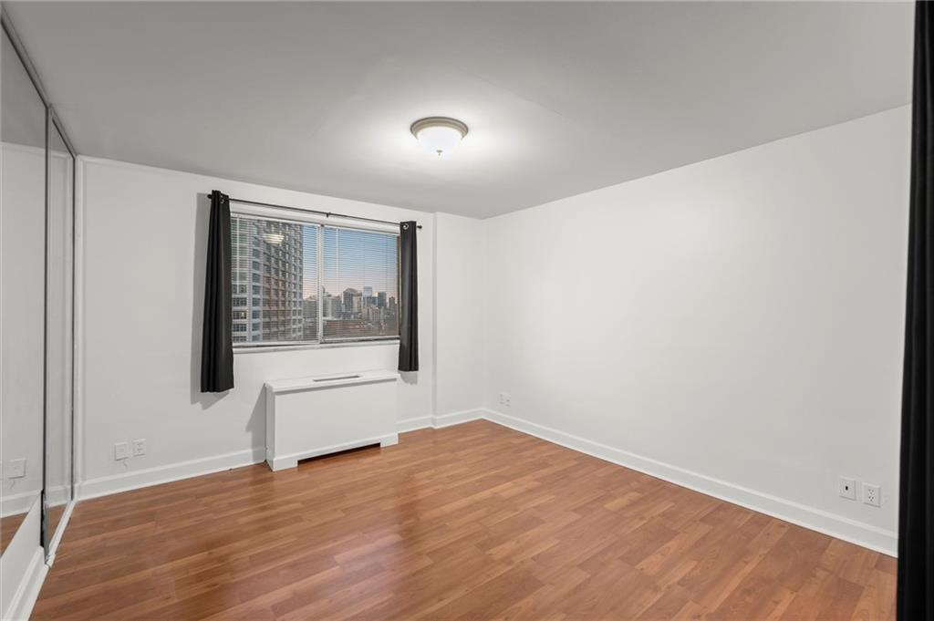 215 Piedmont Avenue Northeast, Unit 1608 Atlanta, GA 30308 - Photo 19 of 25 a view of empty room with wooden floor and fan