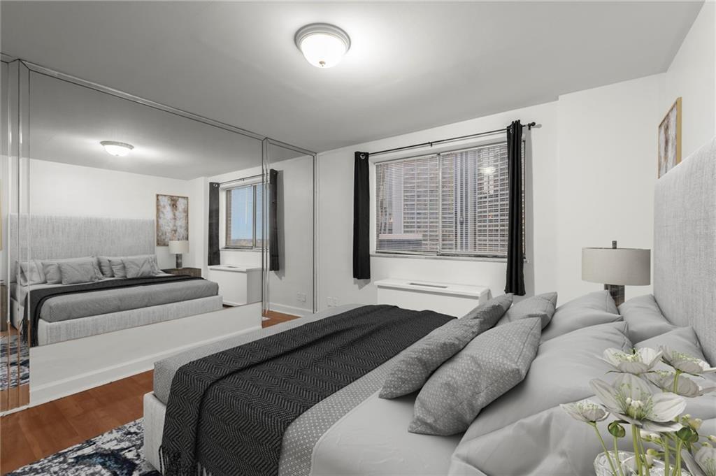 215 Piedmont Avenue Northeast, Unit 1608 Atlanta, GA 30308 - Photo 7 of 25 a bedroom with a large bed and a large window