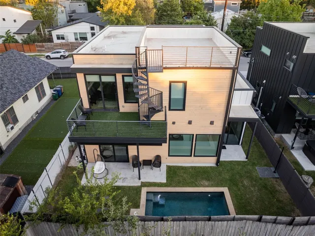 a view of a backyard with swimming pool