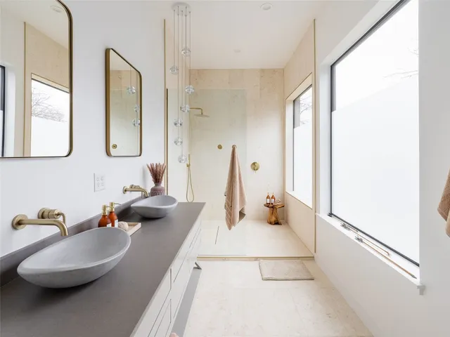 a living room with a couch and a potted plant