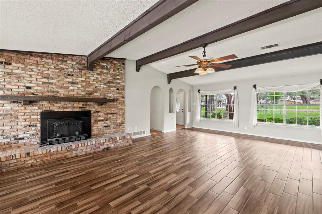 111 Deer Island Road Mabank, TX 75156 - Photo 9 of 26 Living space with wood burning fireplace, vaulted ceilings.