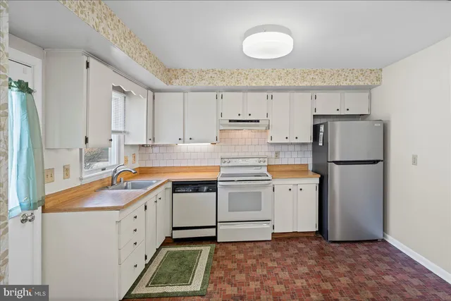 a kitchen with a sink stove and refrigerator