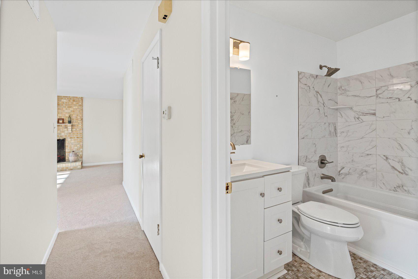 4006 Silvage Road Baltimore, MD 21236 - Photo 30 of 44 a bathroom with a granite countertop toilet a sink and a bathtub