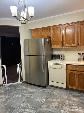 a kitchen with a refrigerator and a sink