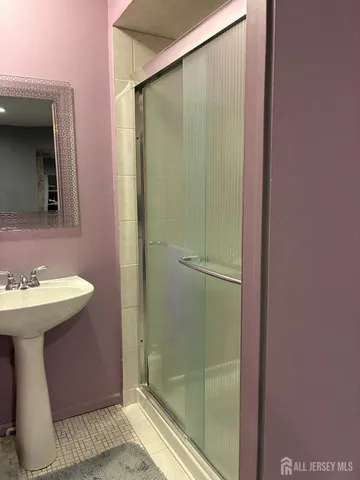 a bathroom with a sink a mirror and shower