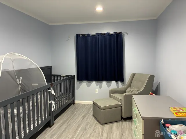 a bedroom with furniture and a wooden floor