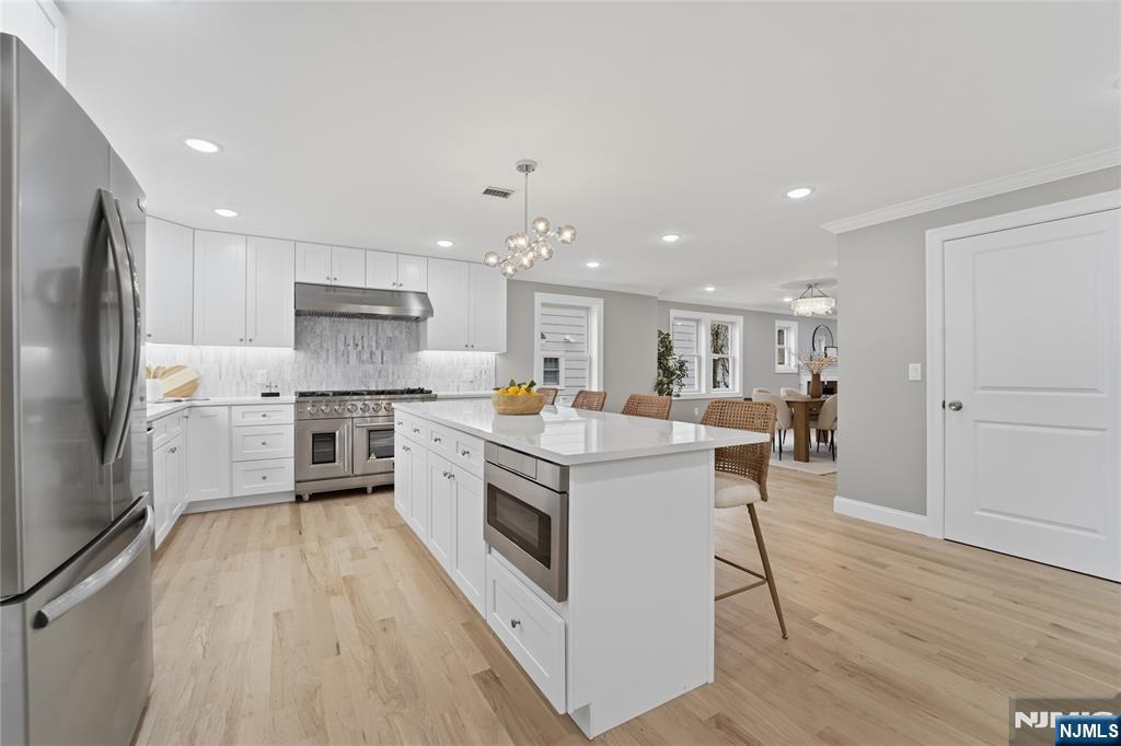 64 Morningside Road Verona, NJ 07044 - Photo 12 of 49 a kitchen with white cabinets stainless steel appliances and a counter top space
